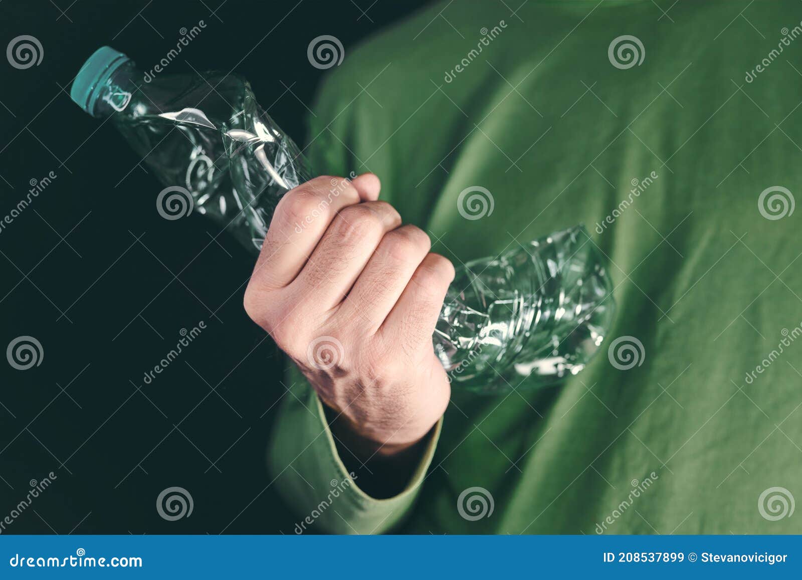 environmentalism  ecology activist crushing plastic bottle in hand