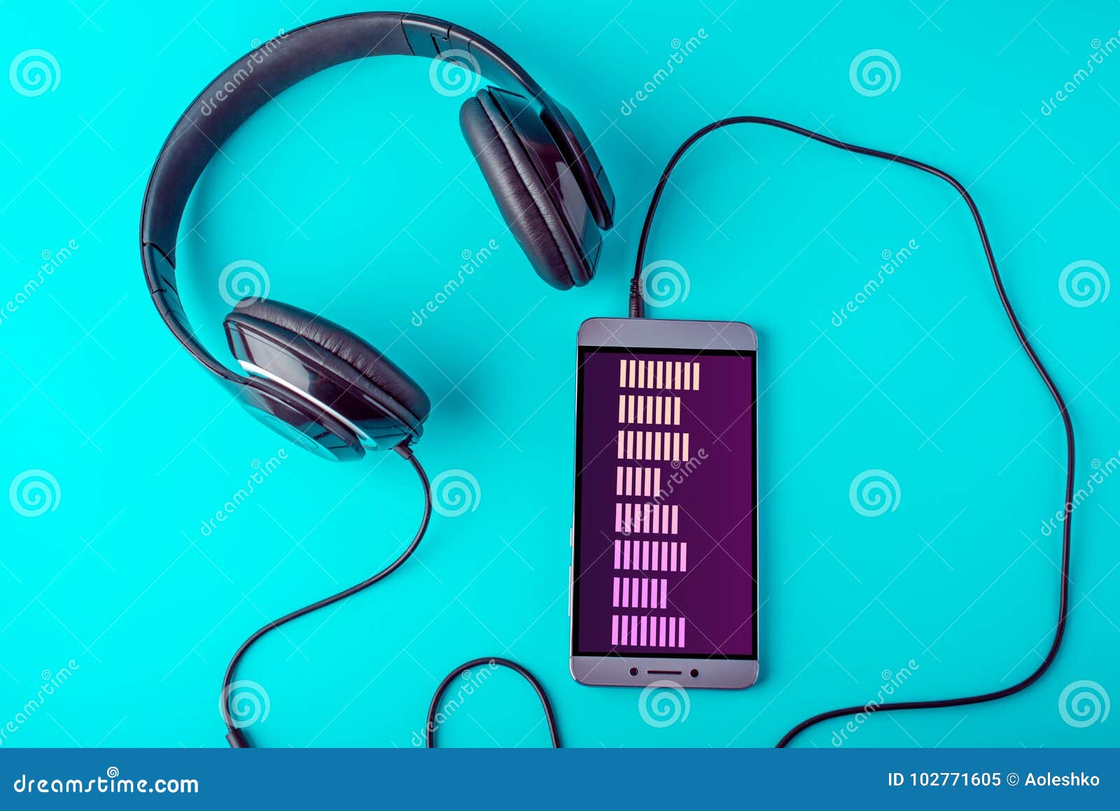 Equalizer on the Screen of the Phone with Headphones Playing Music on a