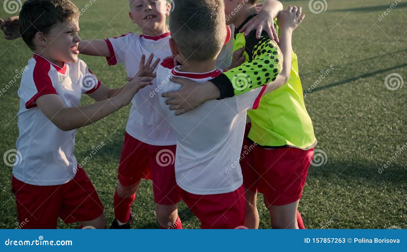 Equipe De Futebol Infantil Se Abraça No Campo De Futebol Antes Do