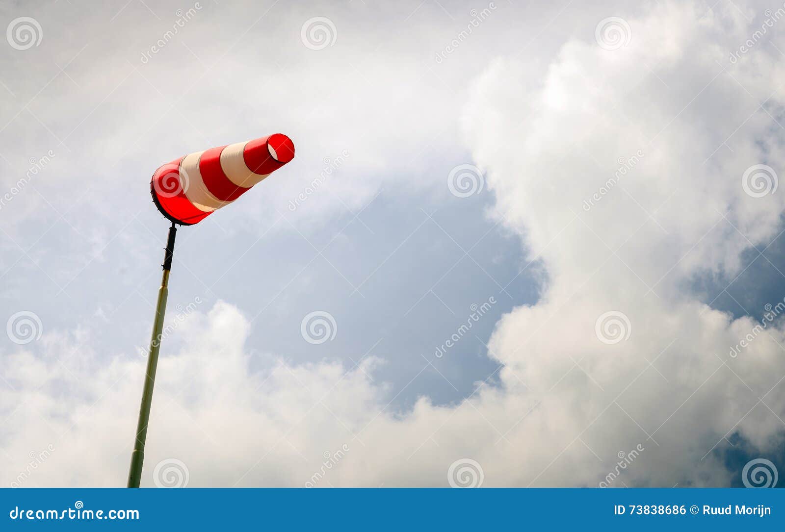 erect red and white windsock on a pole