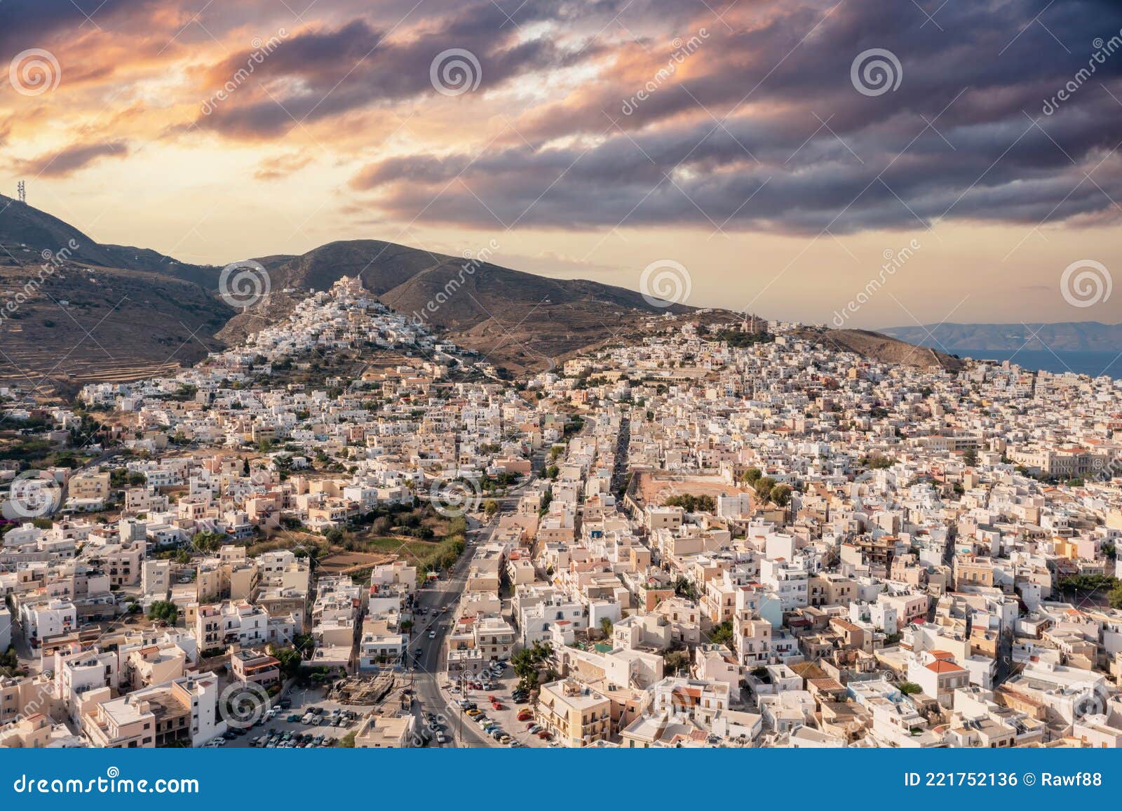 syros island, greece, aerial drone view. ermoupolis and ano siros town cityscape, cloudy sky at sunset
