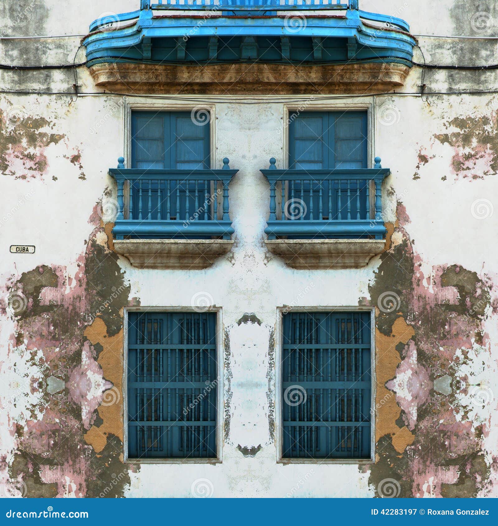 eroded old havana facade with blue windows