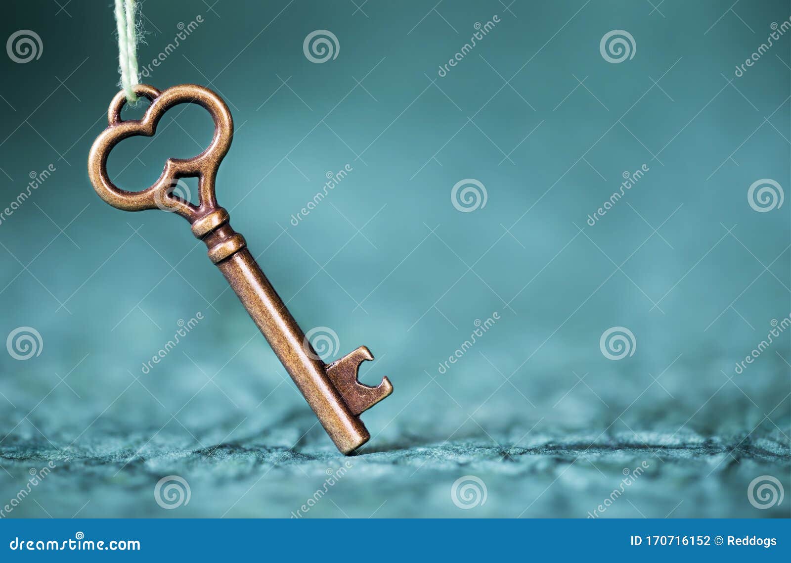 escape room concept. vintage key on blue background with copy space
