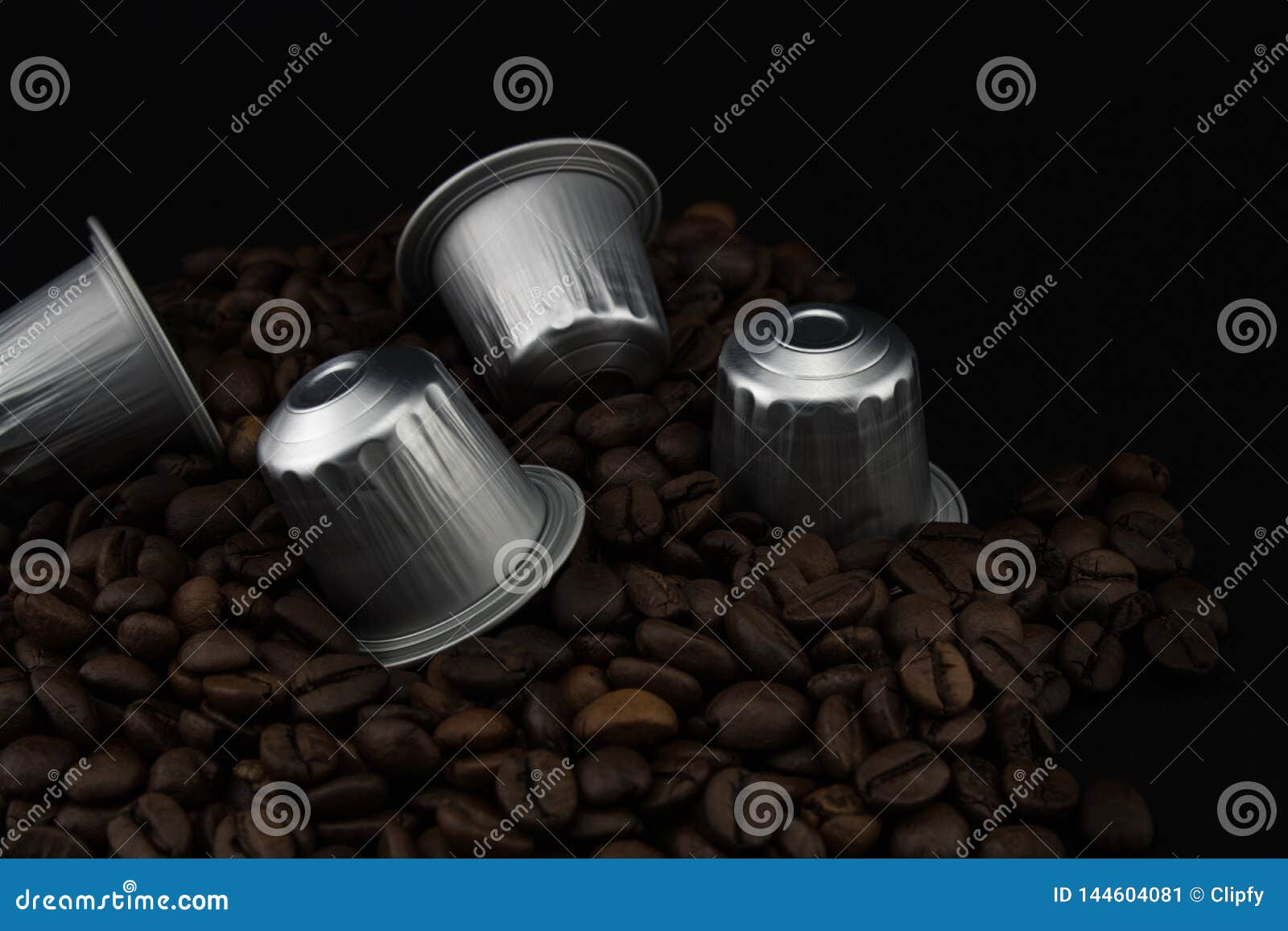 Espresso Coffee Capsules or Coffee Pods on Coffee Beans, Black