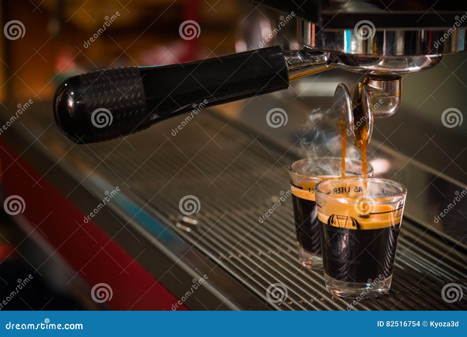 espresso coffee pouring into glass shot