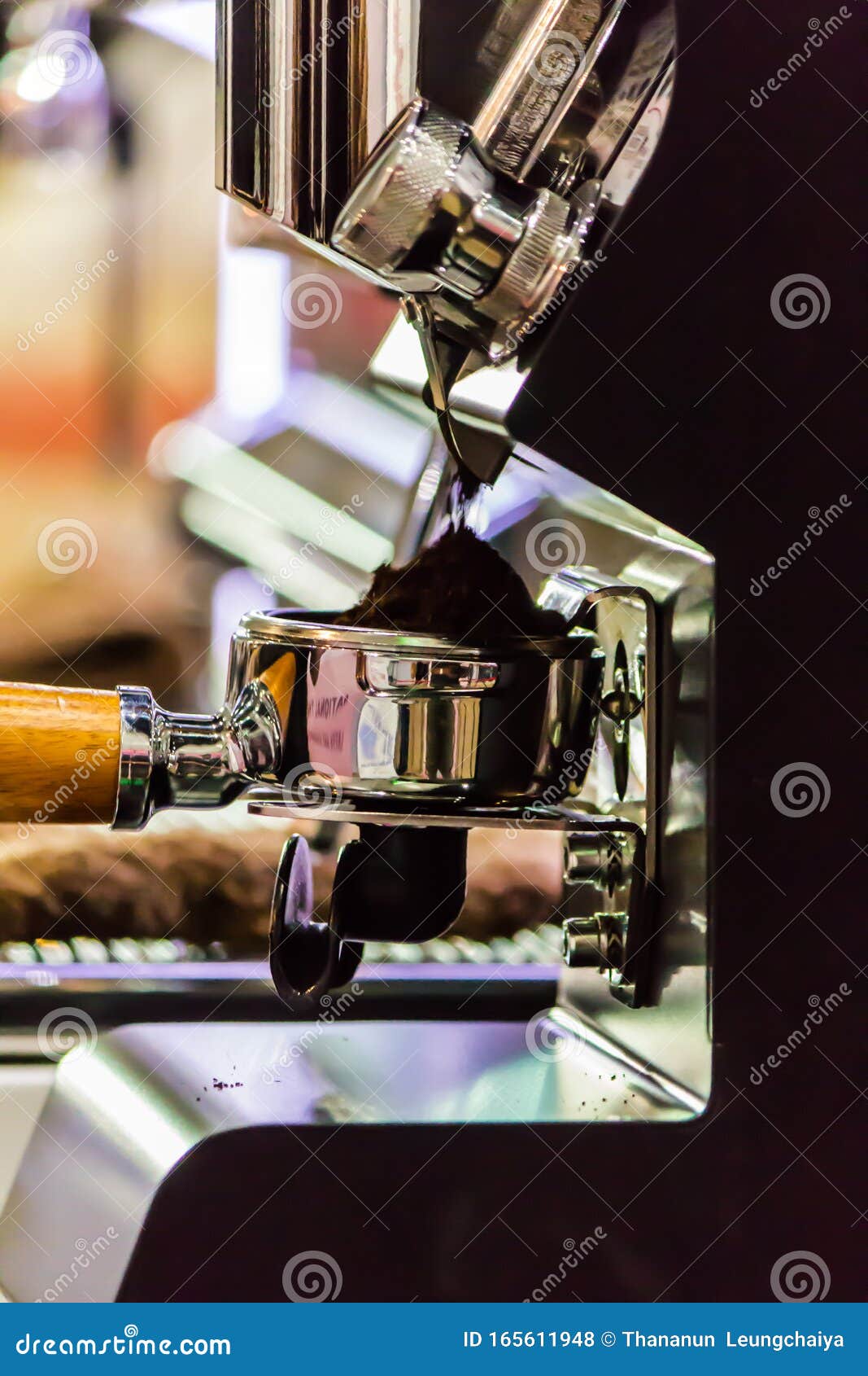 Espresso Machine Grinding Roasted Coffee Bean into Tamper Stock Photo