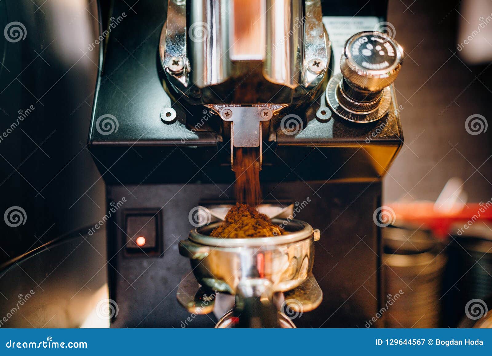 espresso preparation details - coffee being grinded into the portafilter