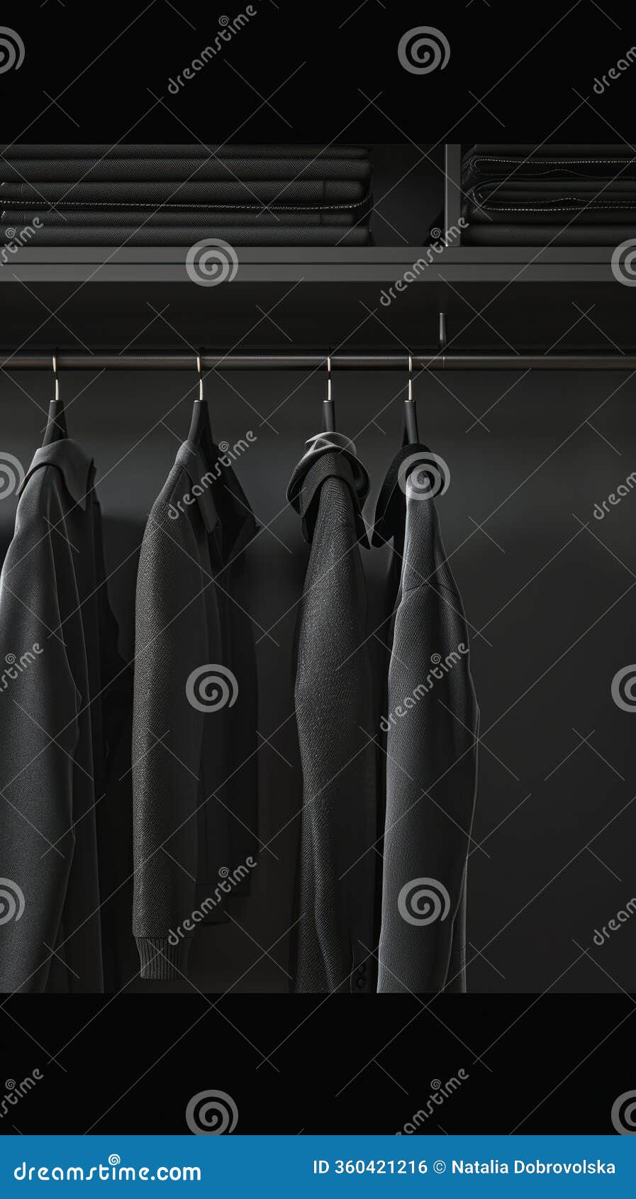 essential black fashion pieces for spring, arranged on a minimalist rack.