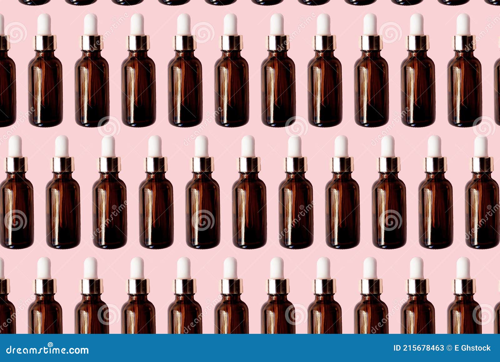 essential oil serum glass bottle pattern  on pink background. natural serums. cosmetic concept