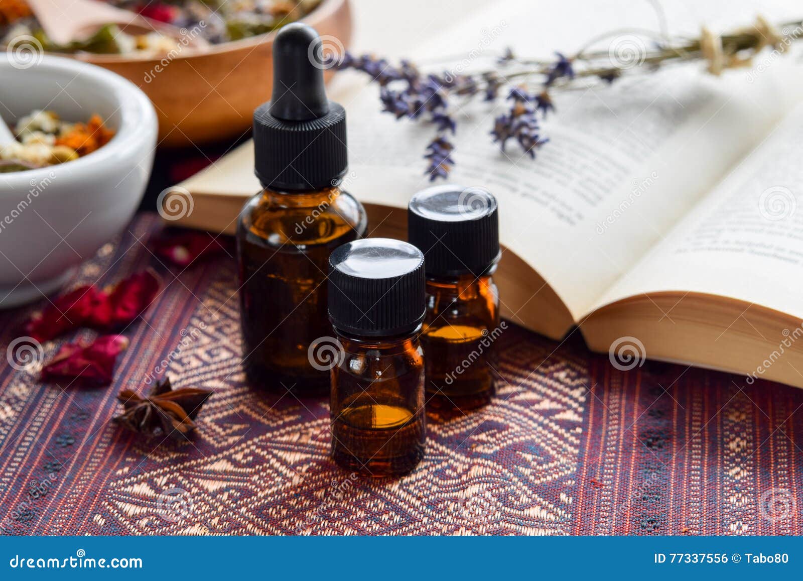 essential oils with herbs and book