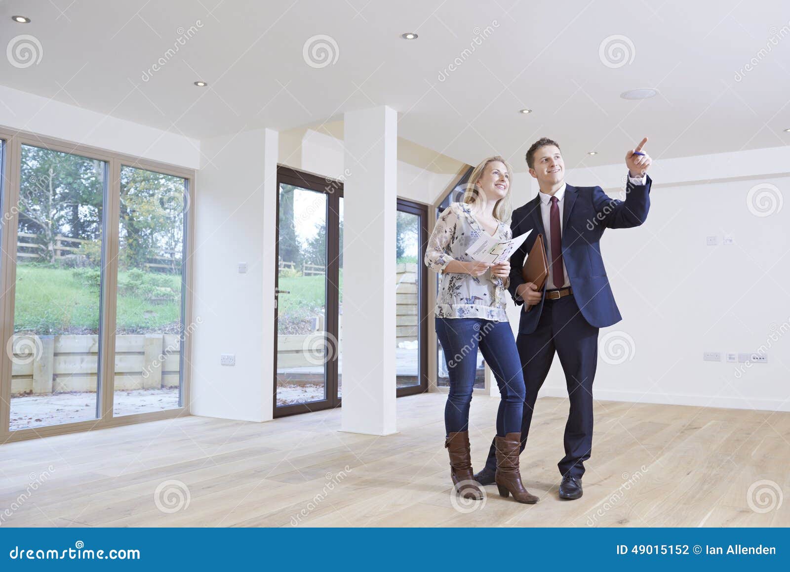 estate agent showing prospective female buyer around property
