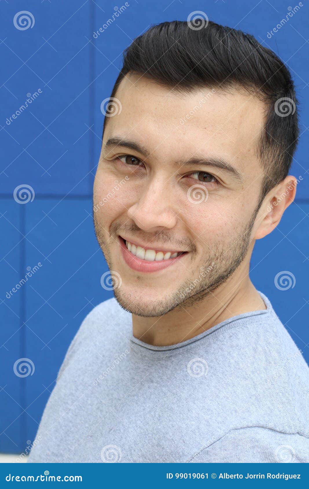 ethnically ambiguous male smiling close up