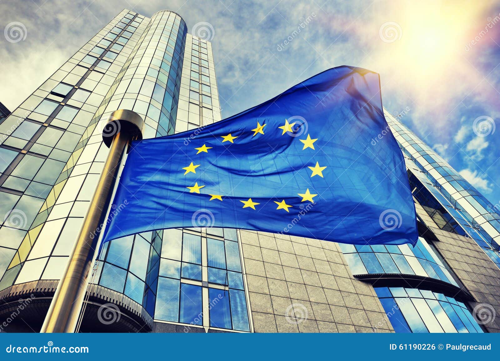 eu flag waving in front of european parliament building in bruss