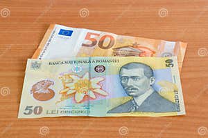 50 Euro Banknote EUR And 50 Romanian Lei Banknote RON On Wooden Table 