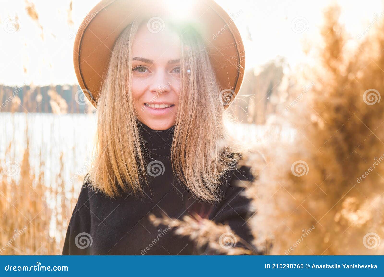 European Blonde Woman With Beige Hat In Black Sweater In The Countryside Golden Hour