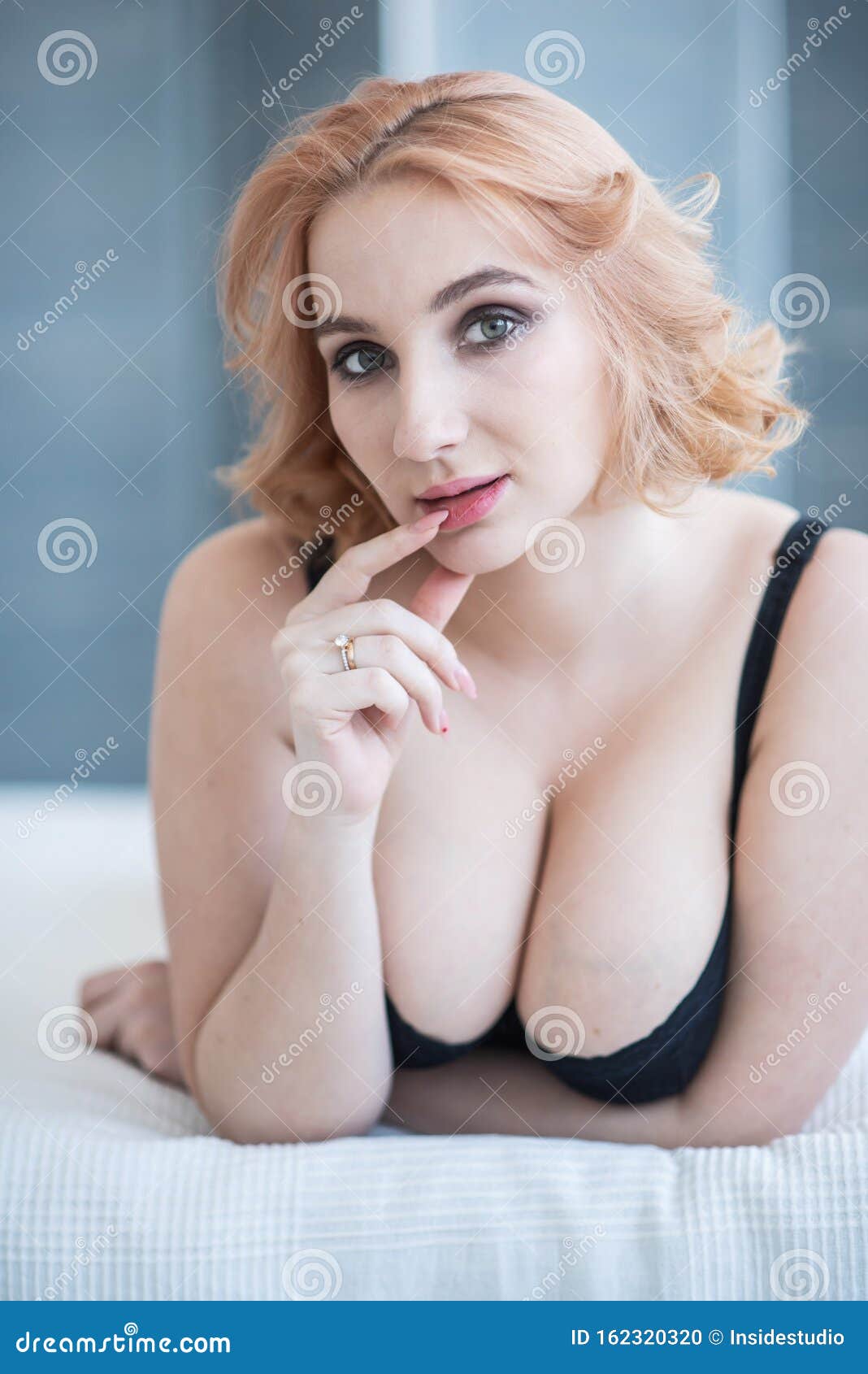A European Girl with a Cute Face and Big Breasts in Black