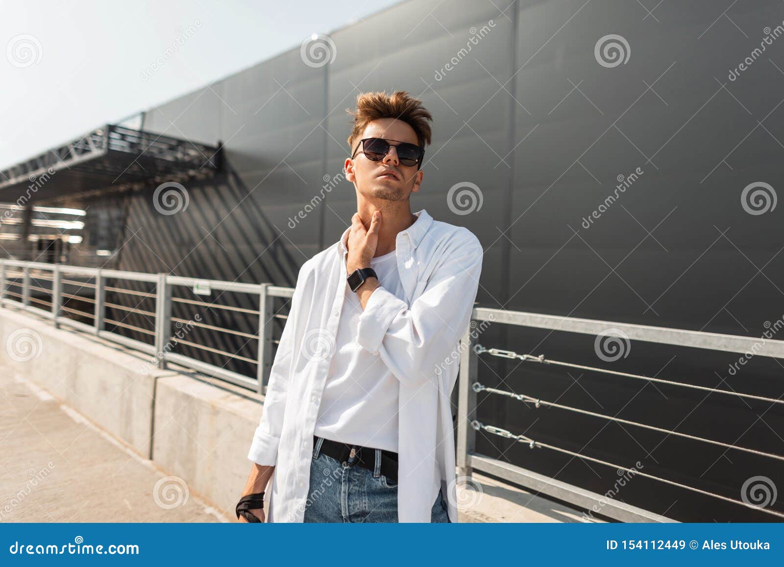 European Stylish Young Hipster Man in Fashionable Summer Clothes in Black  Sunglasses with a Fashionable Hairstyle Stands Stock Image - Image of  hairstyle, city: 154112449