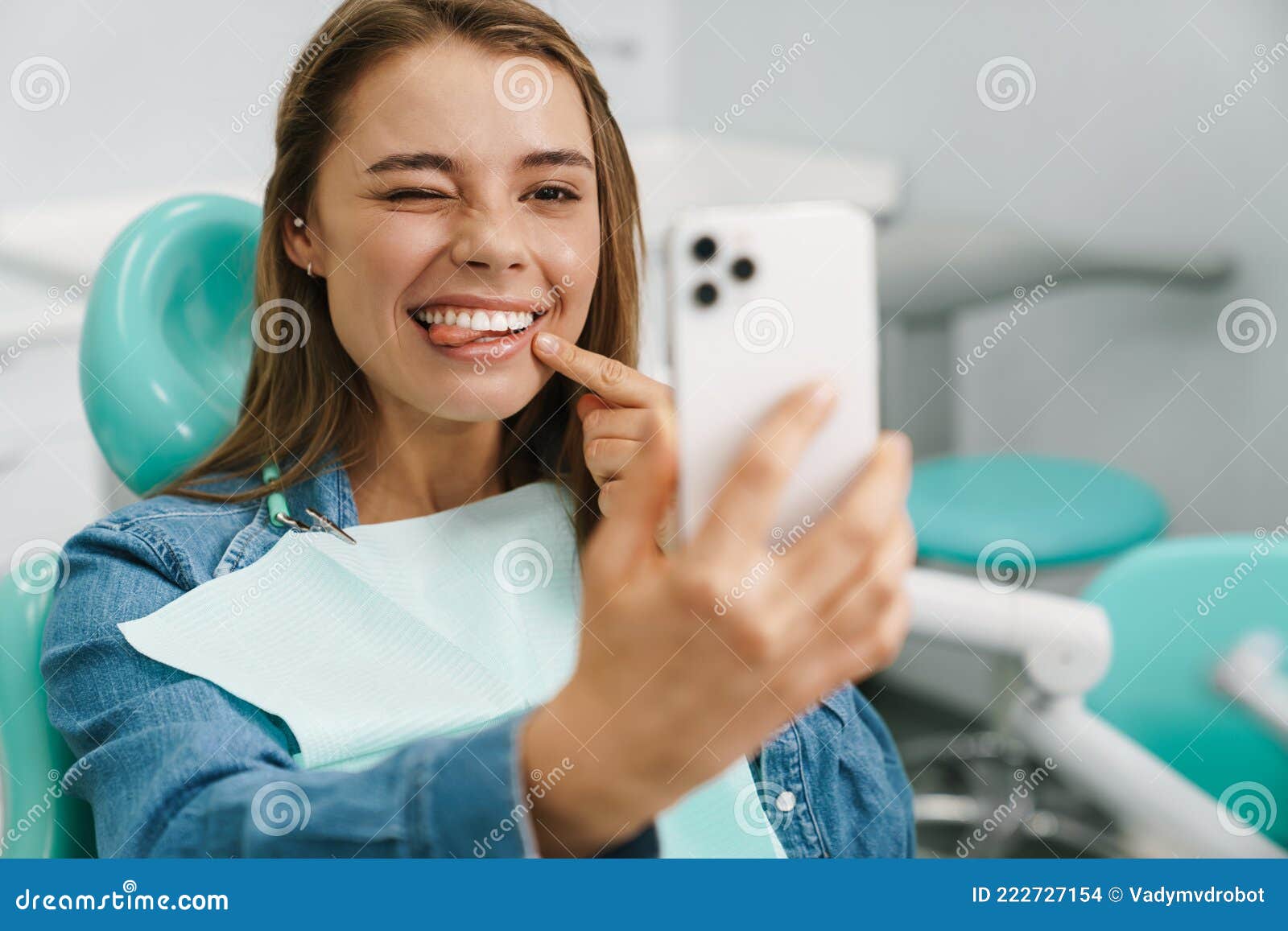 European Young Woman Showing Her Tongue While Taking Selfie On