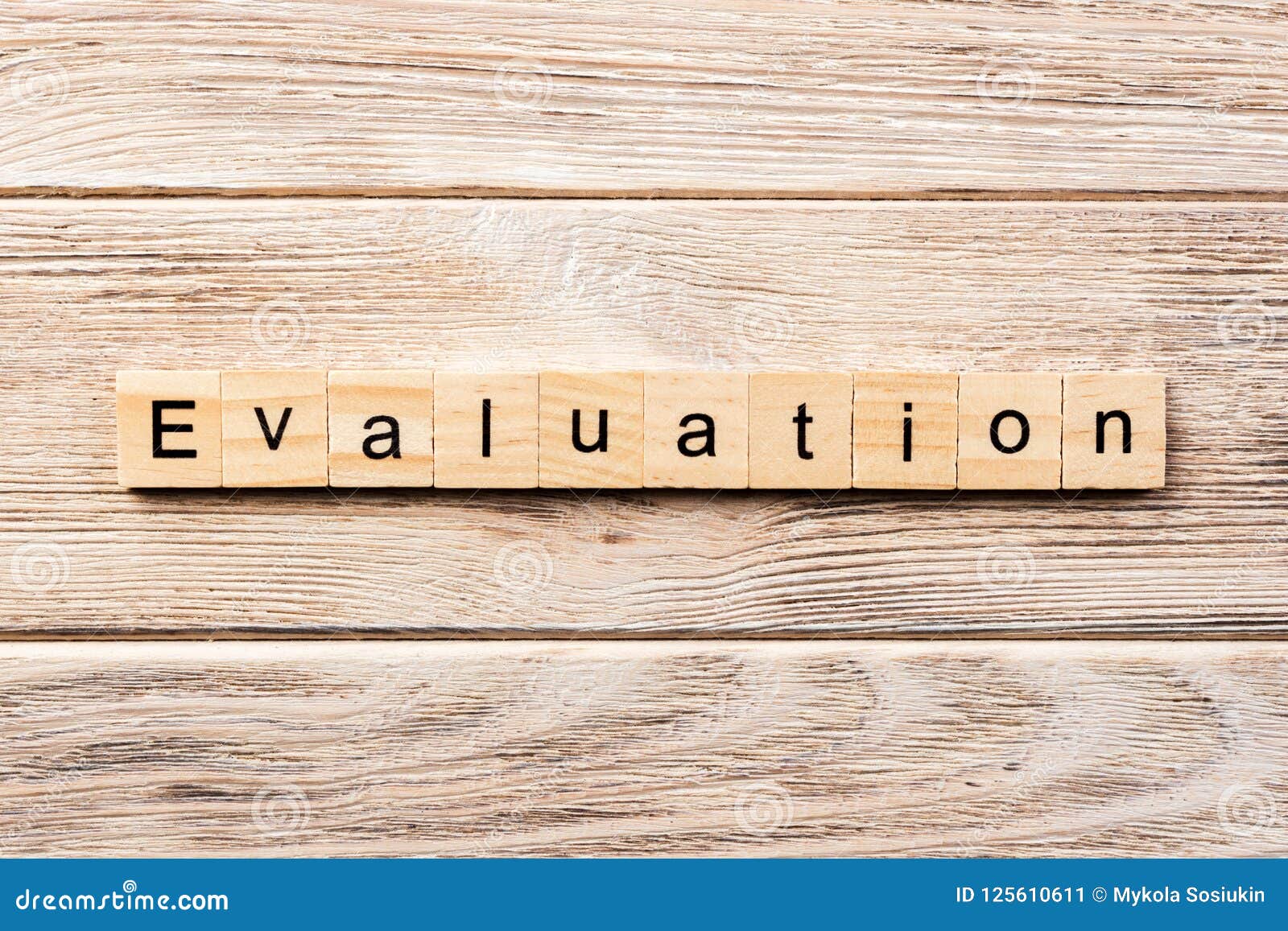 Evaluation Word Written on Wood Block. Evaluation Text on Table
