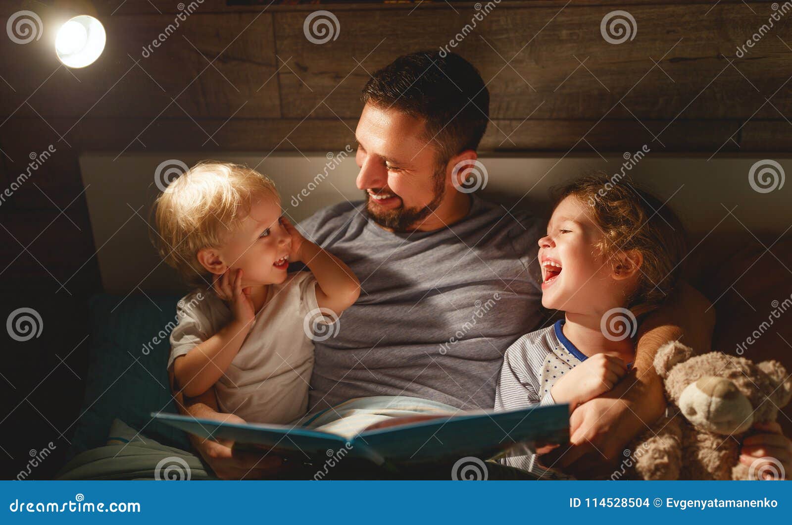 evening family reading. father reads children . book before going to bed