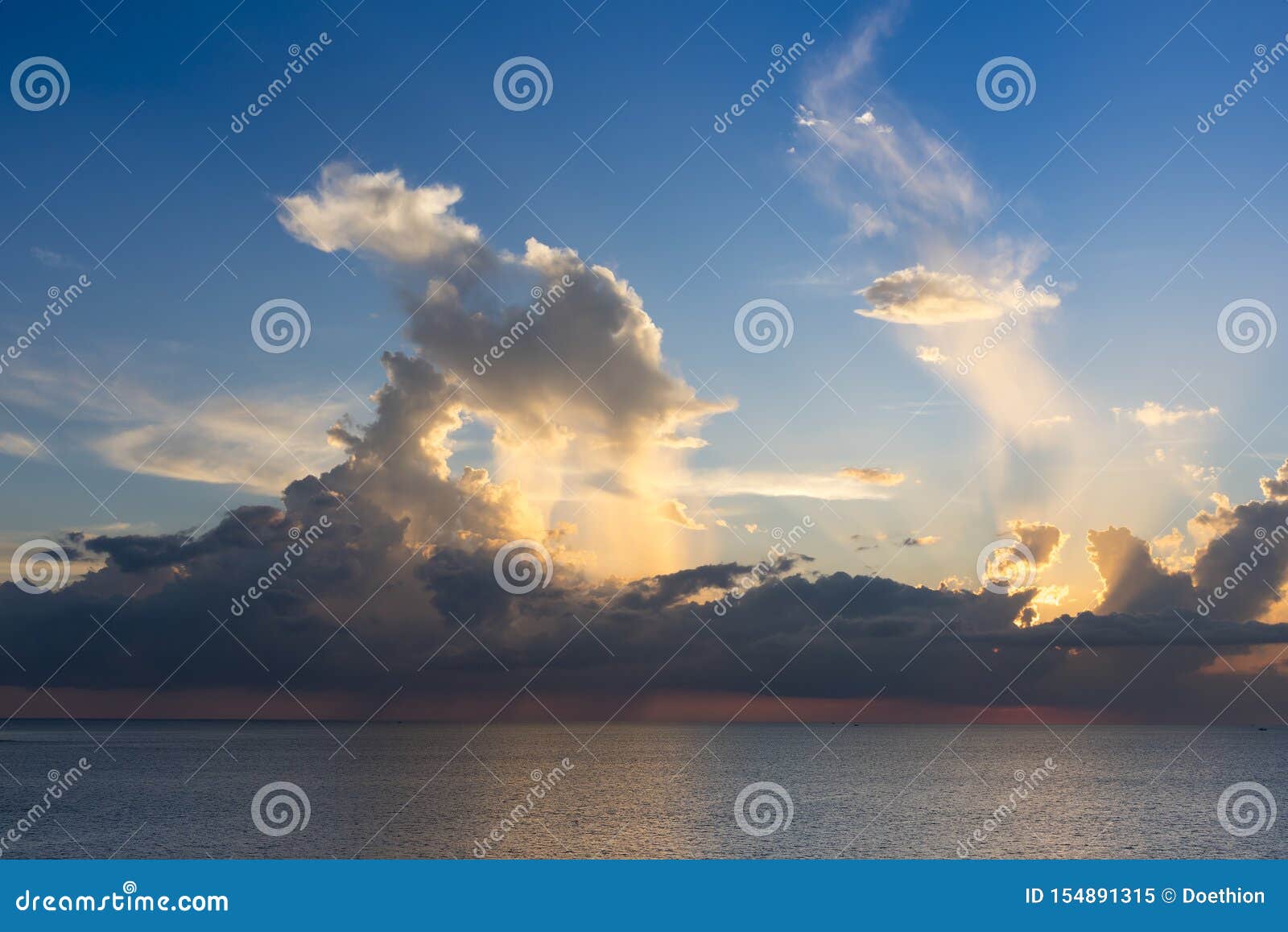 evening sky with dramatic clouds over the sea with sculpted 3d cloudscape