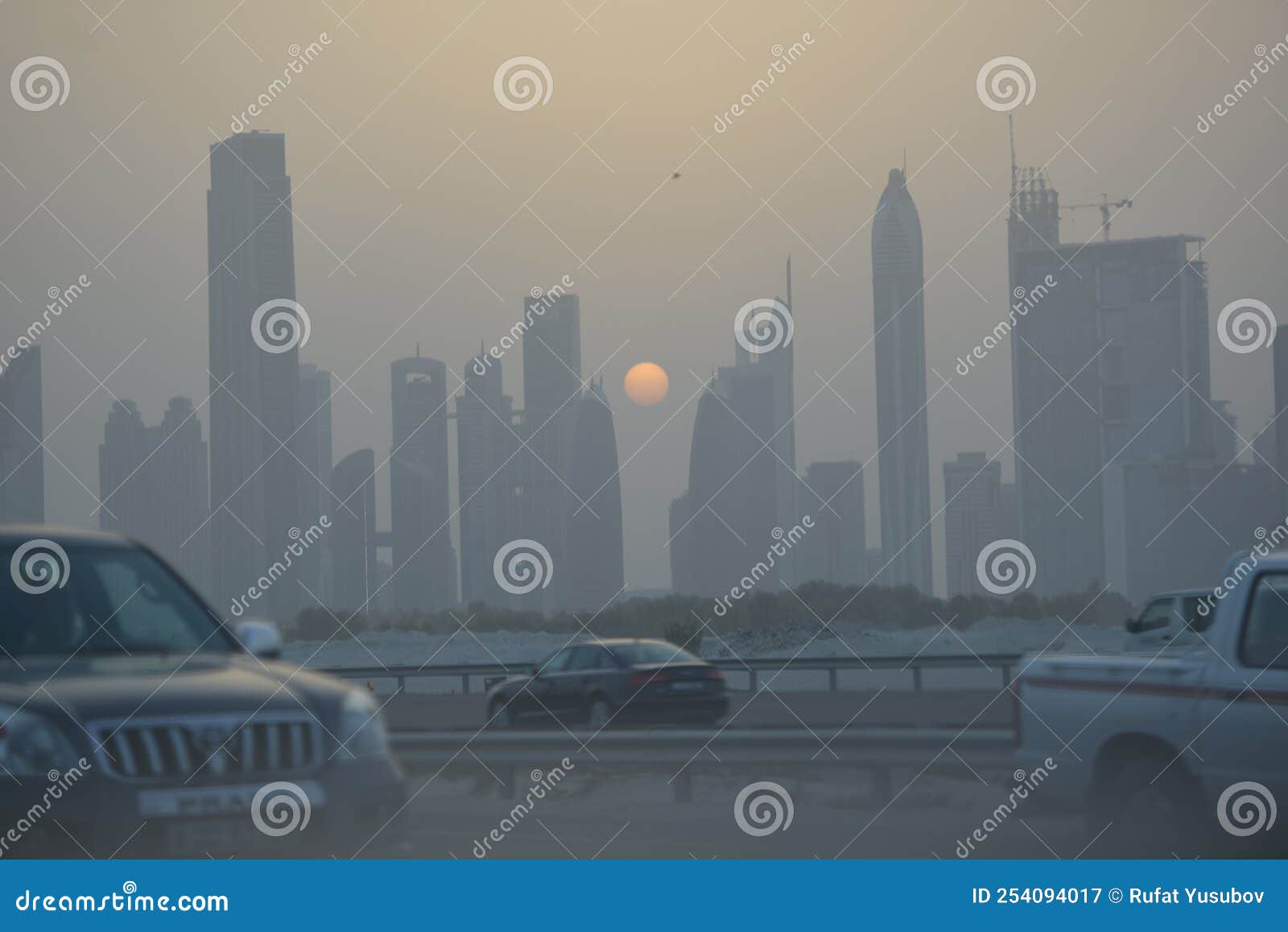 Evening Sunset in Dubai City View Skyscrapers and Setting Sun Editorial