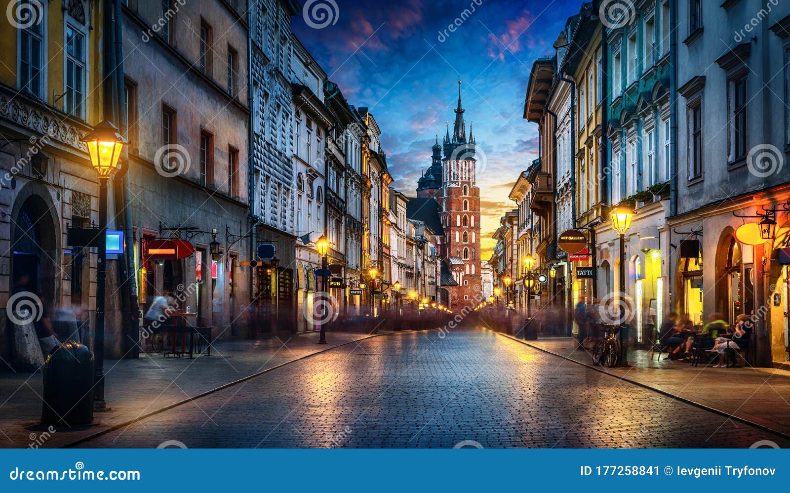 evening view of st. mary`s basilica from the florianska street, old town krakow, poland. panoramic view, long exposure,