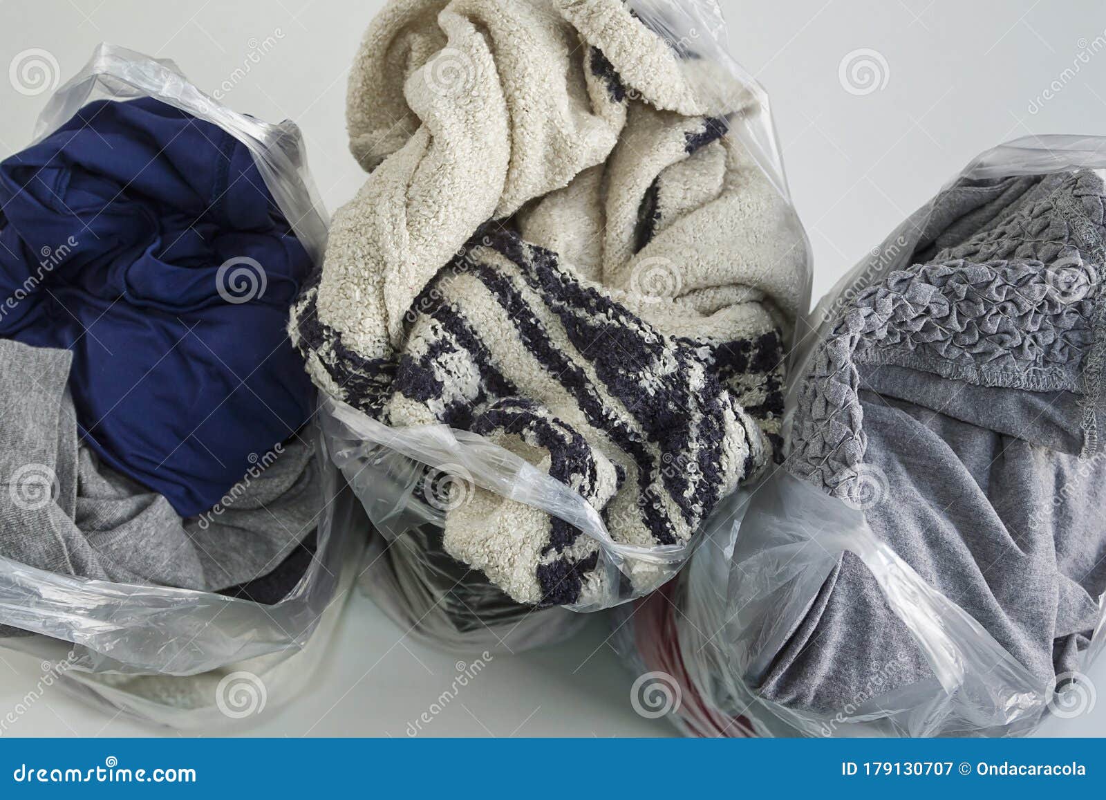 Clothes in plastic bags stock image. Image of environment 179130707
