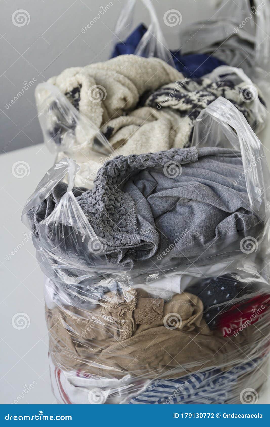 Clothes in plastic bags stock photo. Image of environmental 179130772