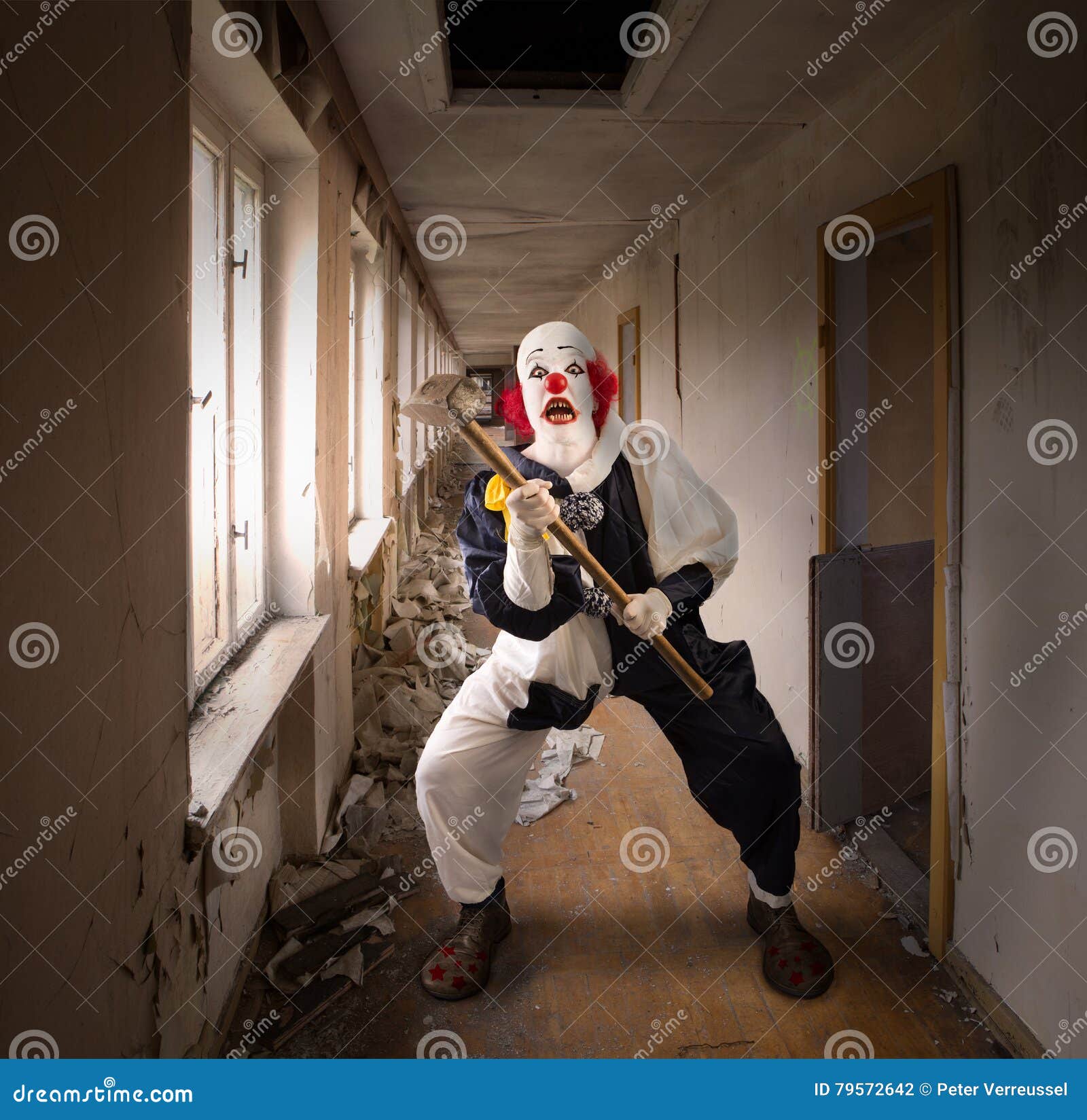 Evil clown with a hammer stock photo. Image of frighten 79572642
