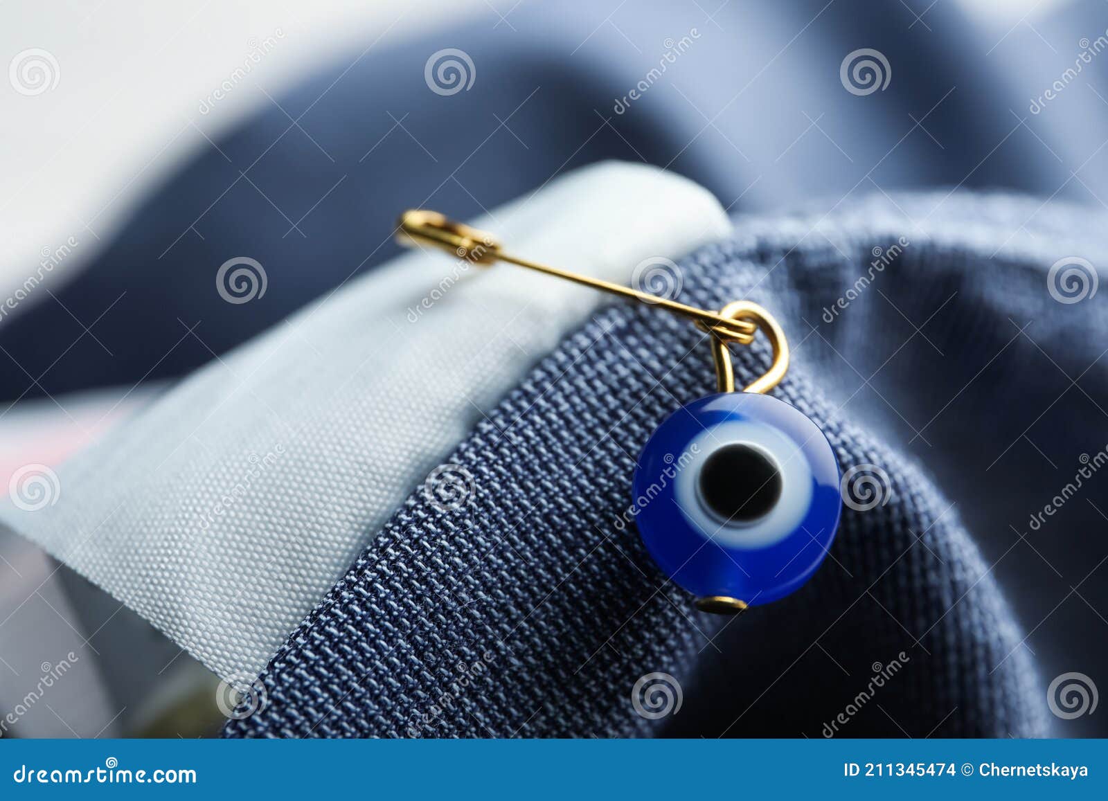 Evil Eye Safety Pin on Clothing, Closeup Stock Photo - Image of