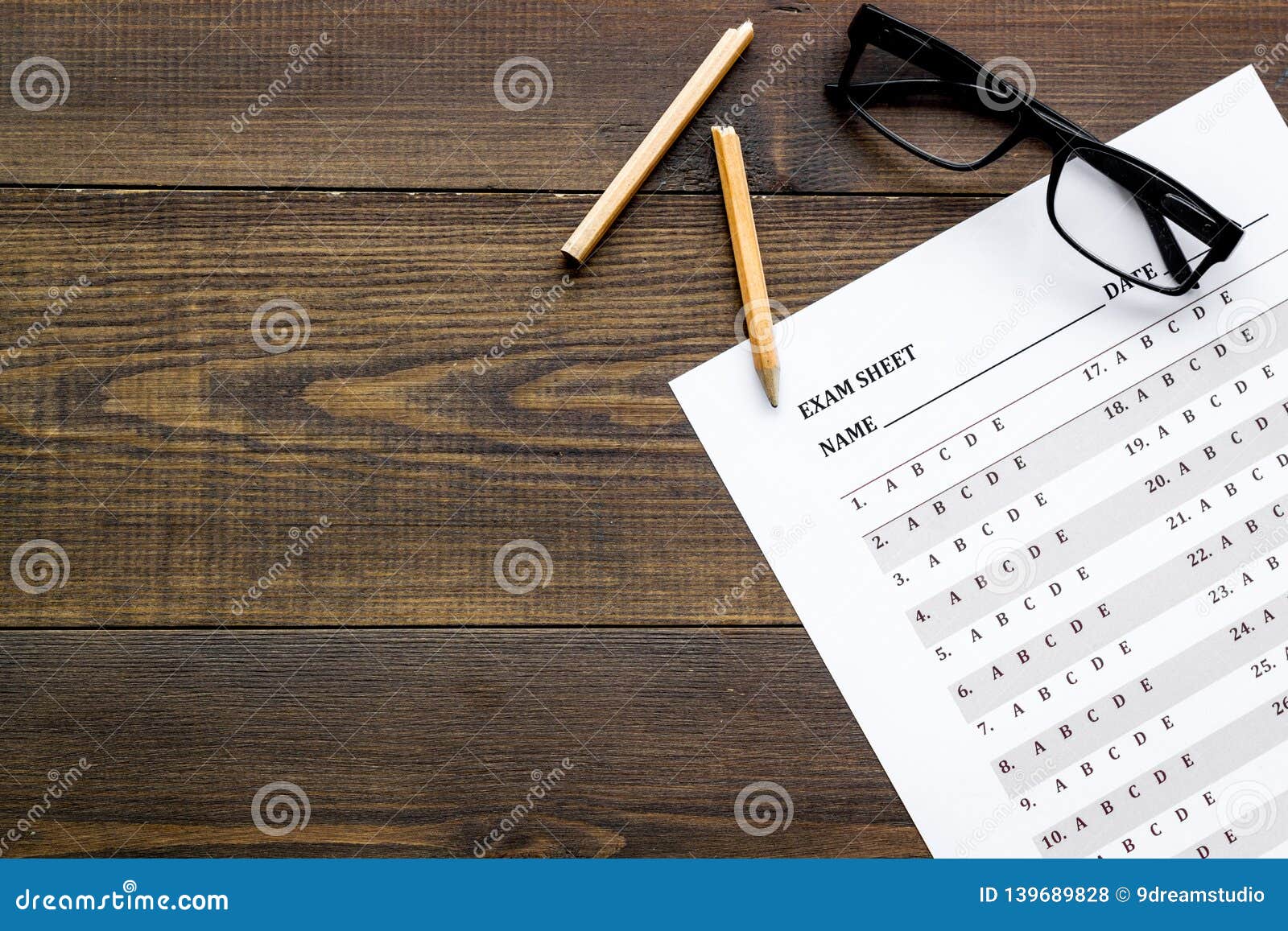 On The Exam Exam Sheet Answer Near Glasses And Pencil On Dark