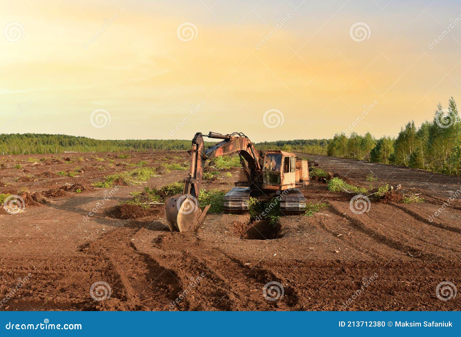 Excavator Digging Drainage Ditch in Peat Extraction Site. Drainage of