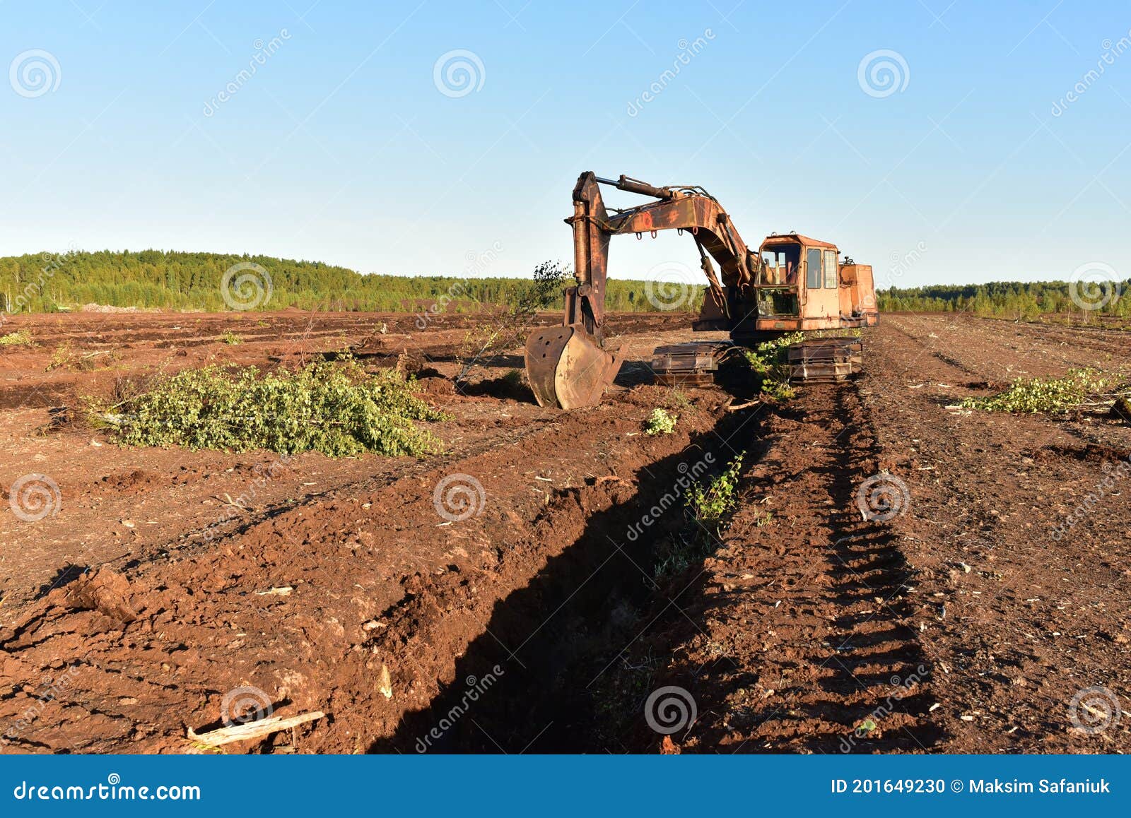 Excavator Digging Drainage Ditch In Peat Extraction Site. Drainage Of