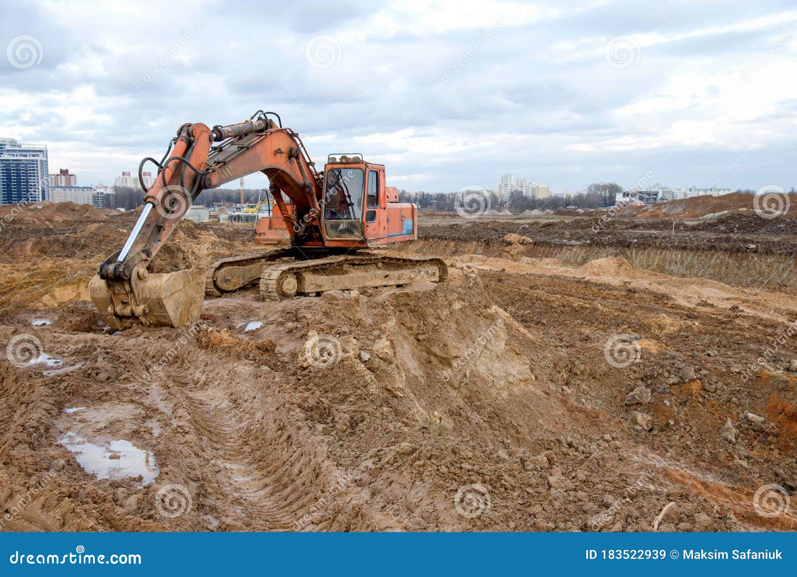 Excavator at Earthworks on Construction Site. Backhoe Loader Digs a Pit