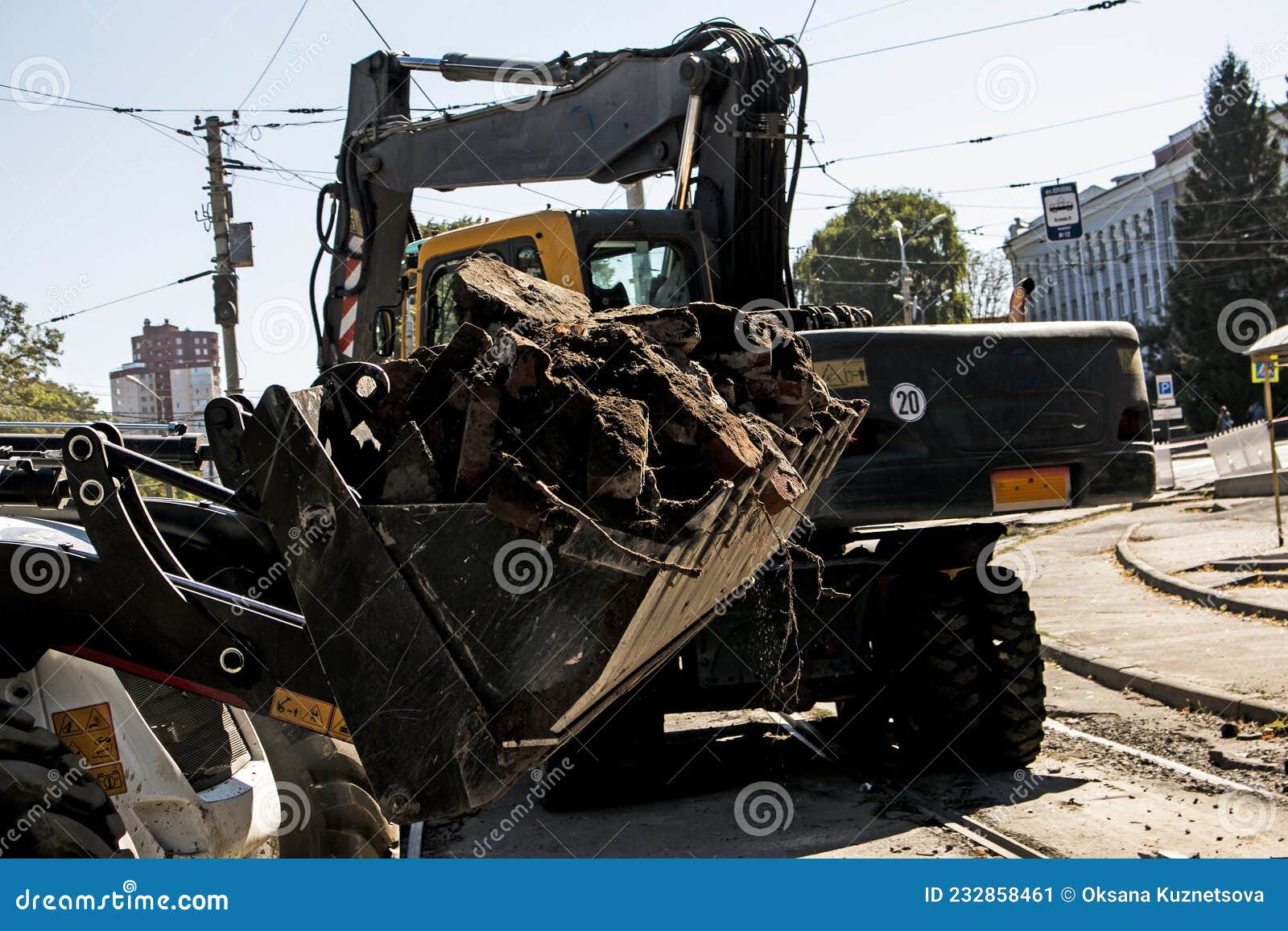 Excavator, Grader and Workers Remove Debris after Dismantling a Tram