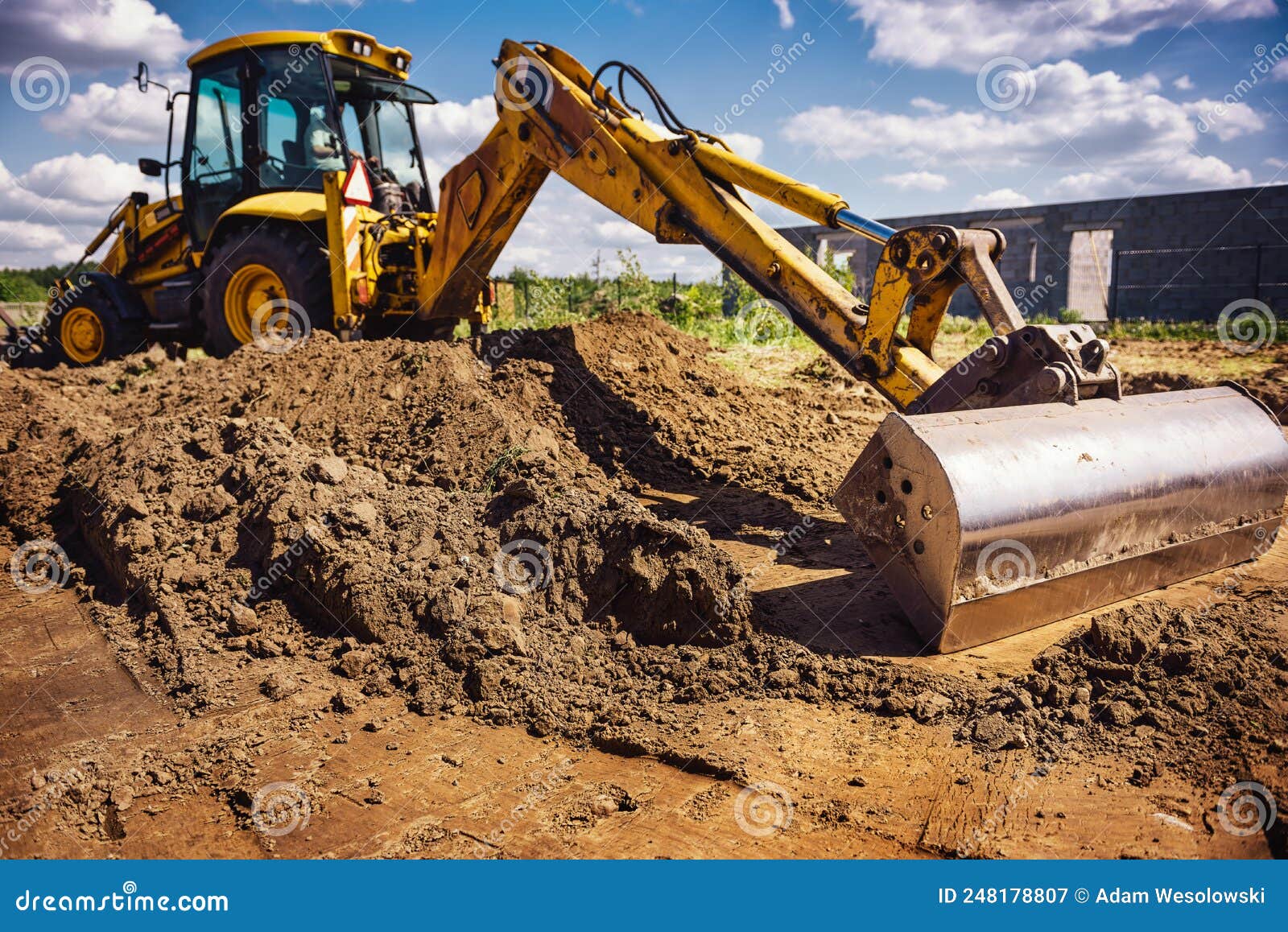 Excavator at House Construction Site Digging Foundations for Modern