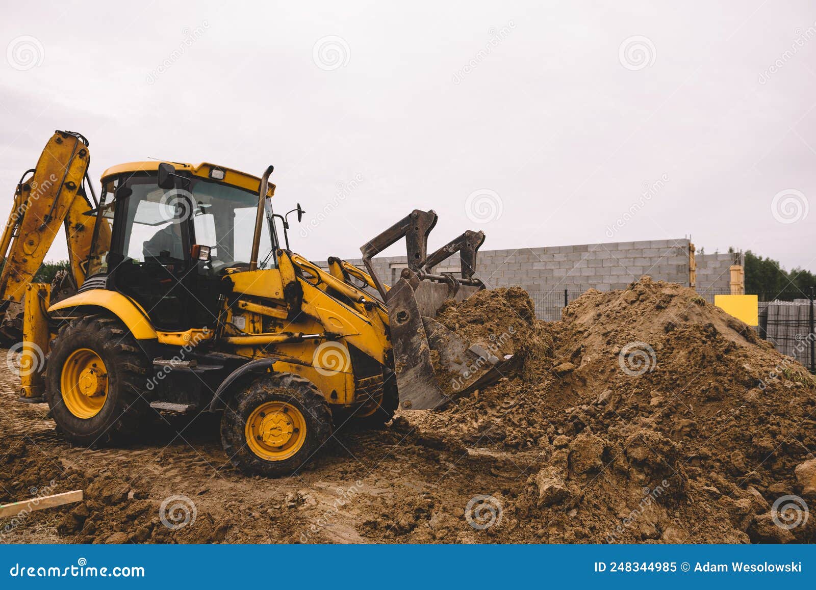 Excavator at House Construction Site Digging Foundations for Modern