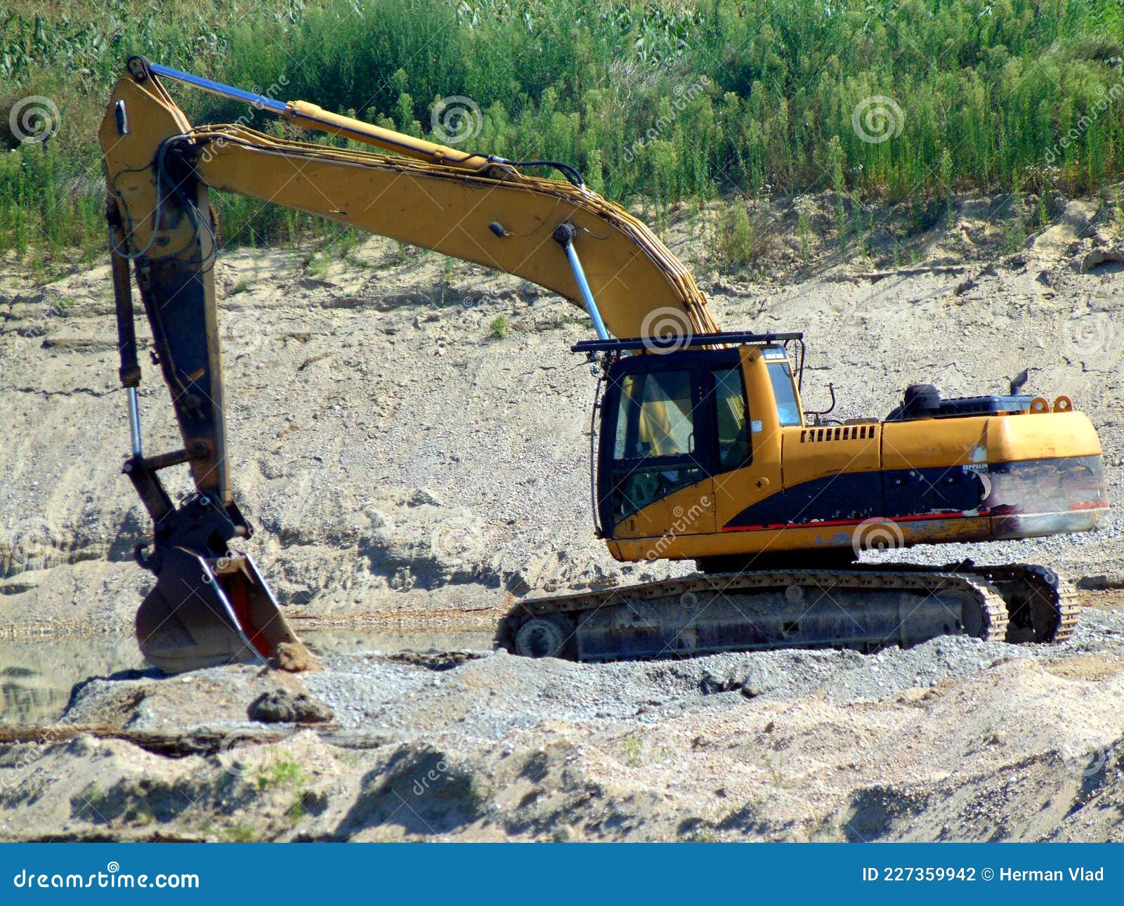 An excavator on the sand stock photo. Image of construction 227359942
