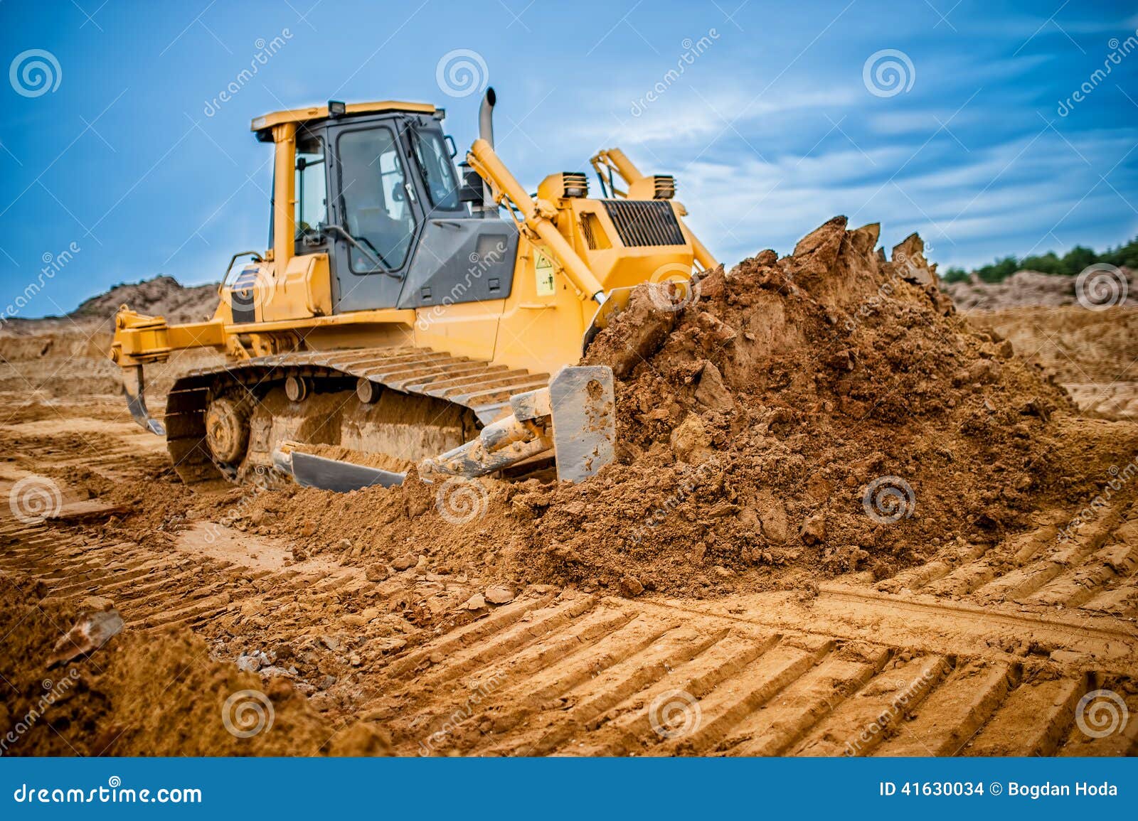 excavator working with earth and sand in sandpit