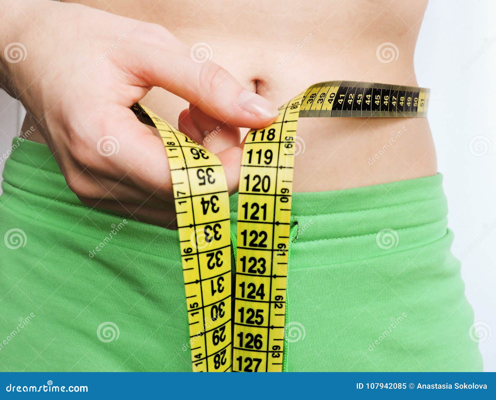 https://thumbs.dreamstime.com/z/excess-belly-fat-measurements-waist-fitness-girl-green-sports-clothing-measuring-her-yellow-tape-workout-107942085.jpg