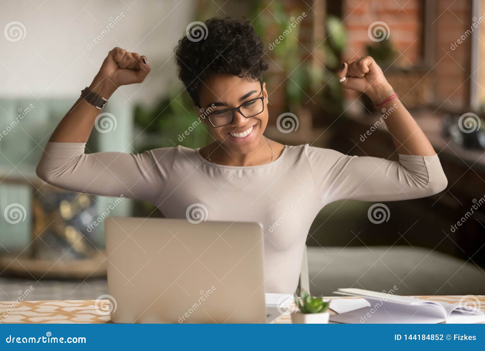 excited african woman feeling winner rejoicing online win on laptop