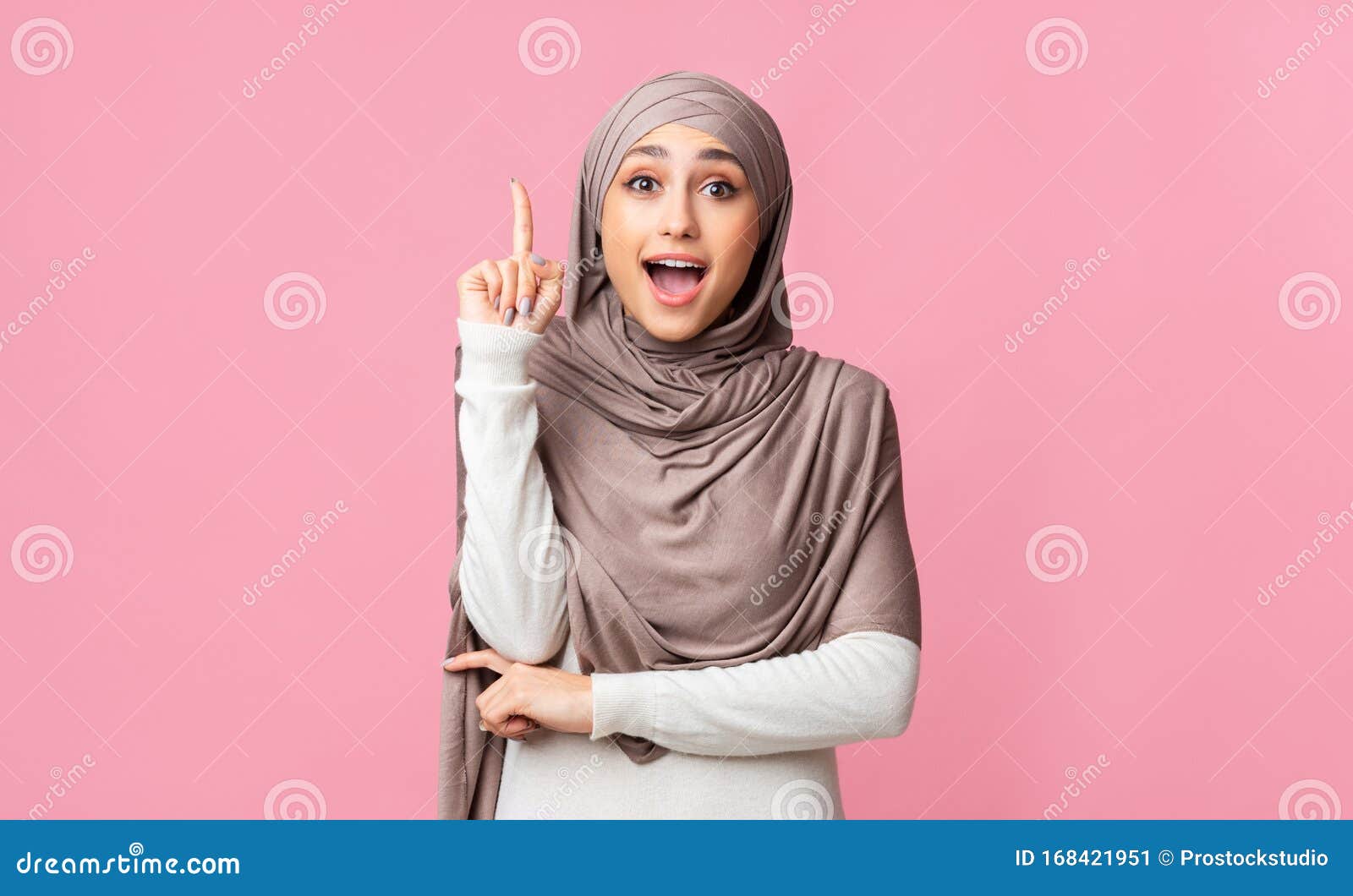 Excited Arabian Woman In Hijab Pointing Finger Up Having Idea Stock