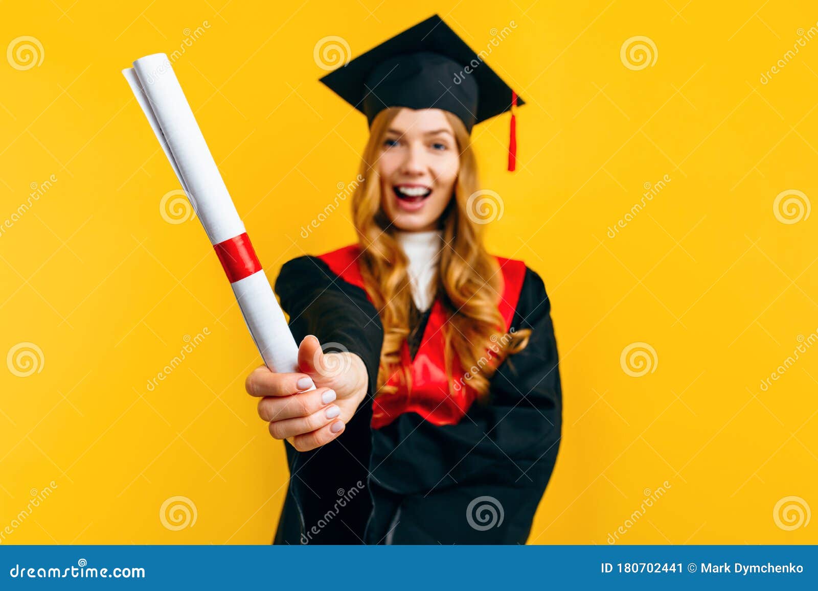 Happy attractive graduate in a master's dress, with a diploma on a yellow  background. Concept of the graduation ceremony Stock Photo - Alamy