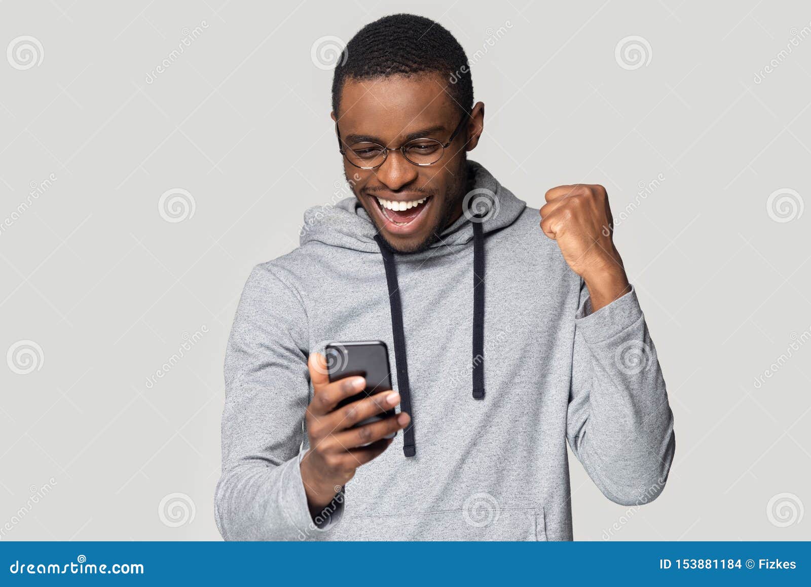 excited black man feel overjoyed reading good news on cellphone
