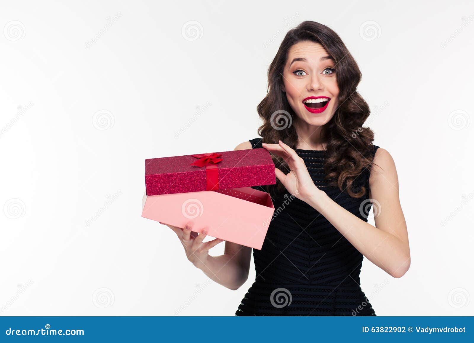 excited cheerful attractive young woman with retro hairstyle opening gift