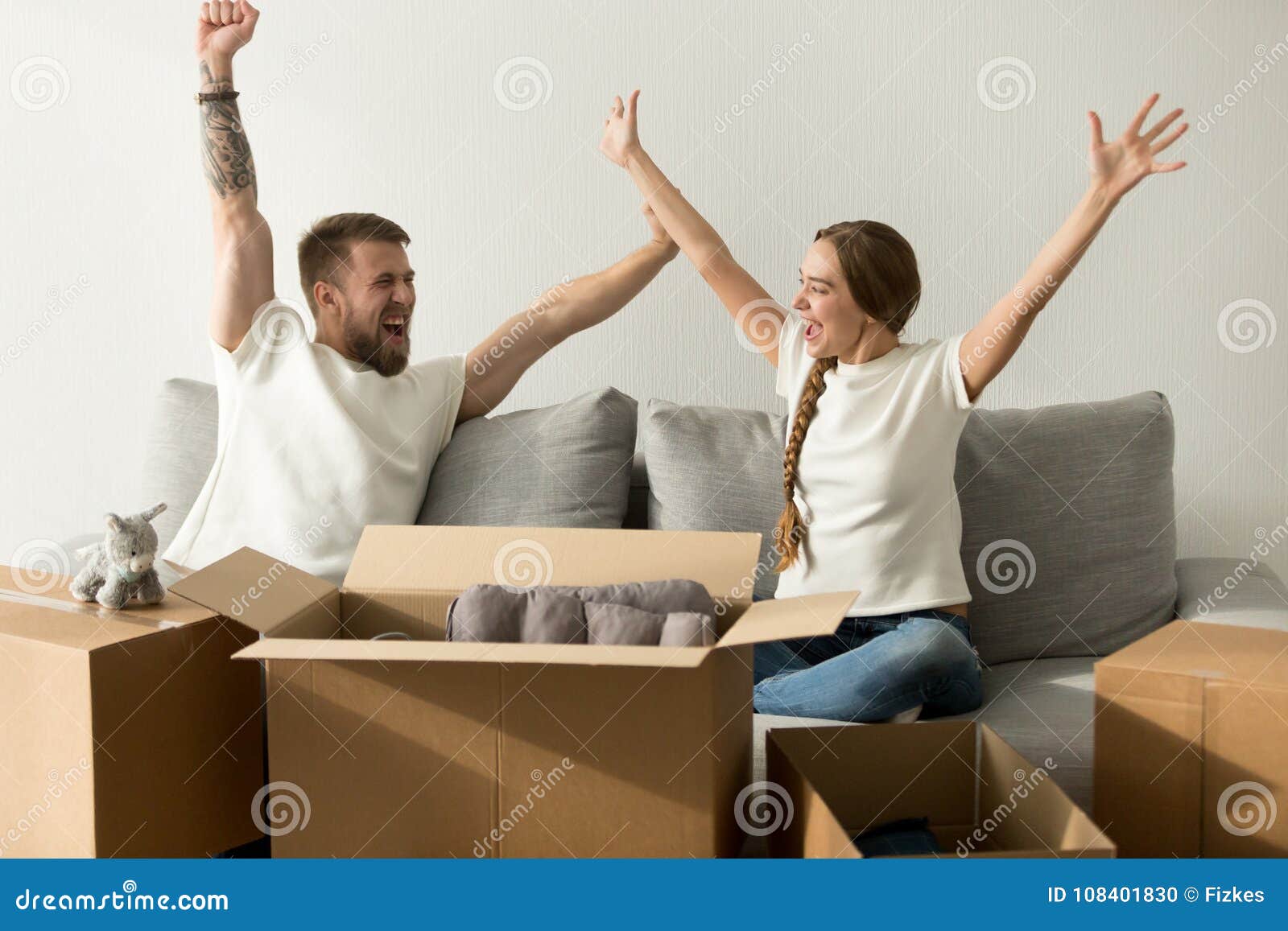 excited couple glad to move into new home celebrating together