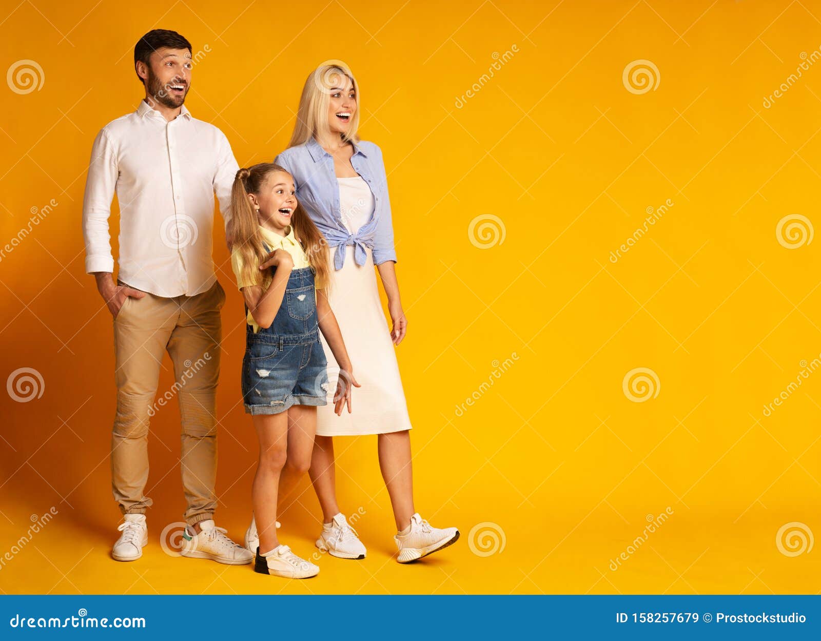 Excited Family Looking at Empty Space Standing Over Yellow Background Stock  Image - Image of parents, three: 158257679