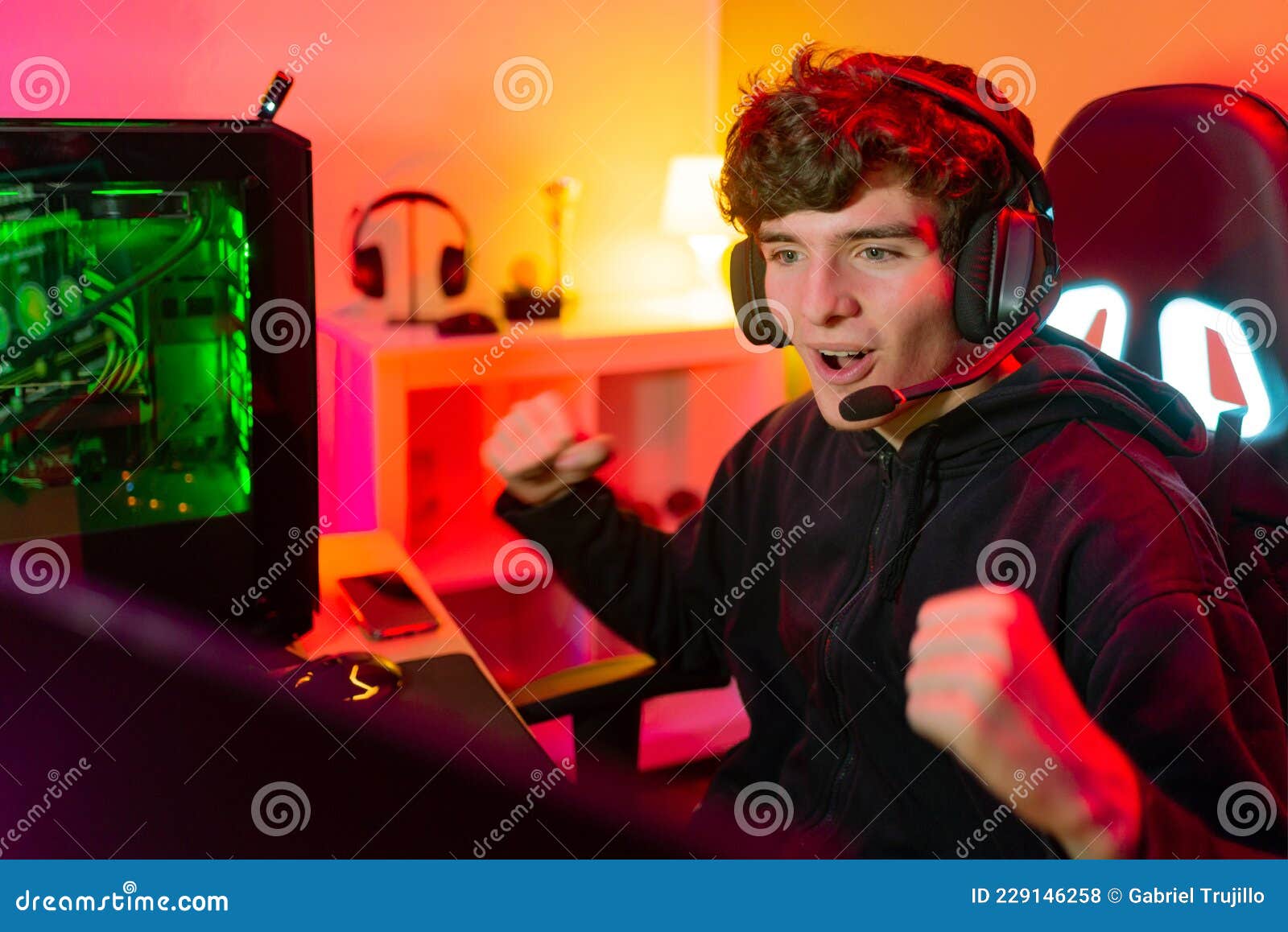 Free Photo  Player winning video games with controller and headset in  front of monitor. man using joystick and headphones, playing online games  on computer. person celebrating game win for leisure.