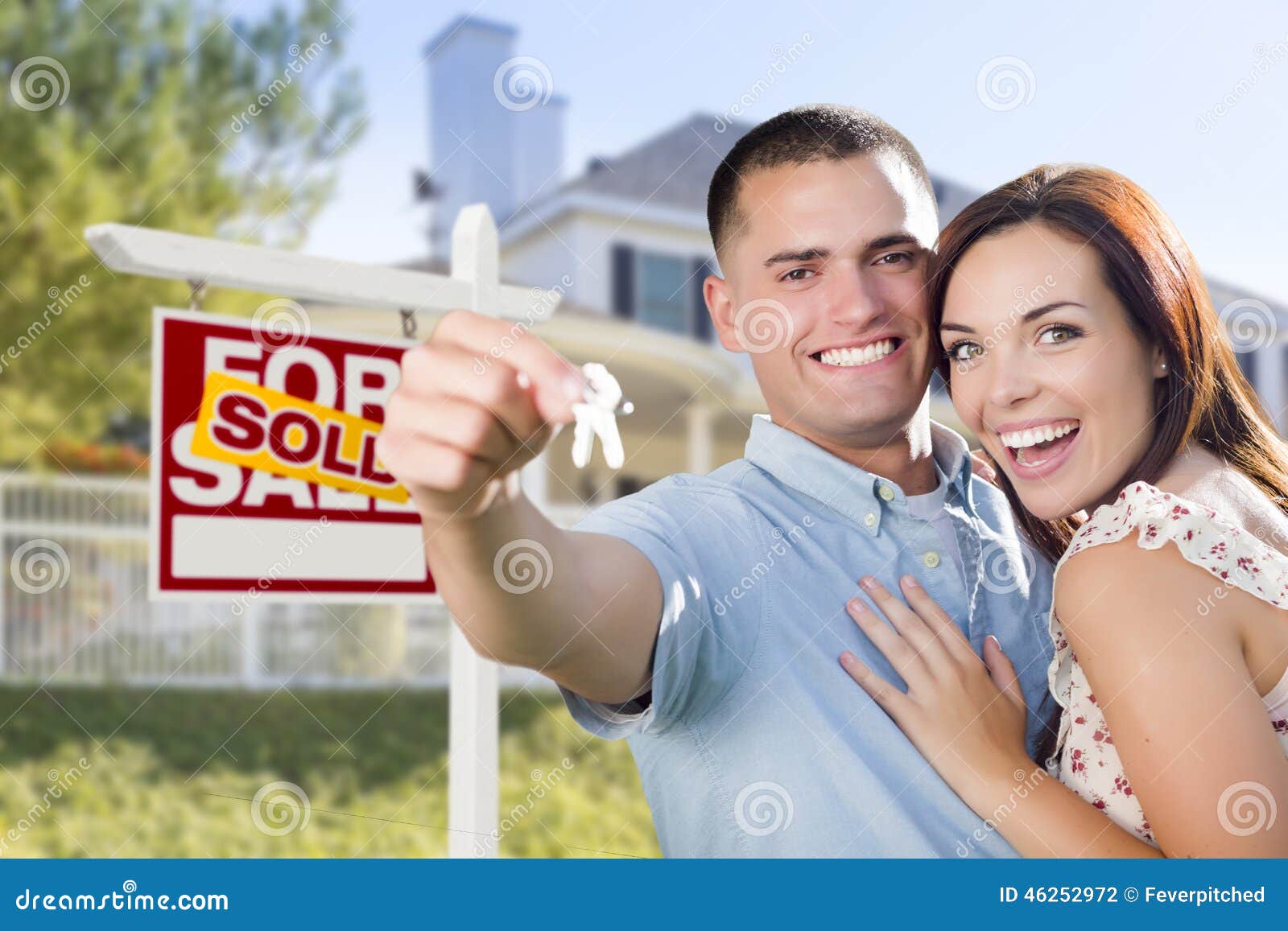 Excited Military Couple In Front Of Home House Keys